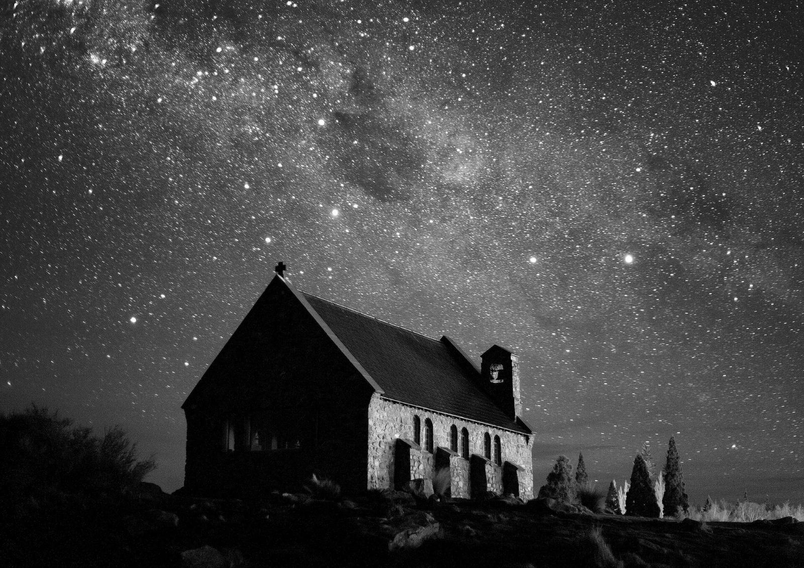 The Milky Way over a stone church on the shore of Lake Tekapo